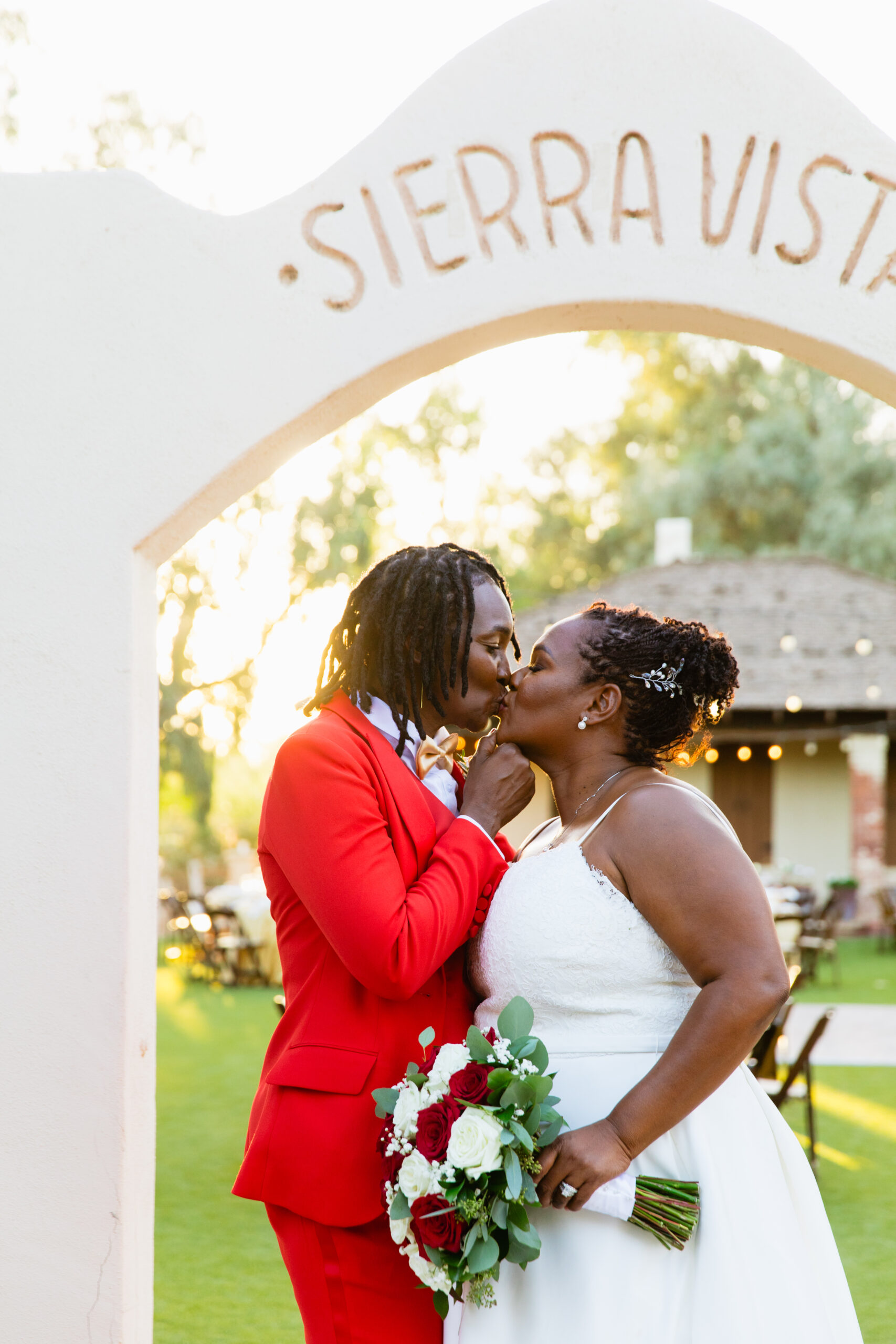 Same sex couple share a kiss during their intimate desert wedding by Phoenix wedding photographer Juniper and Co Photography.