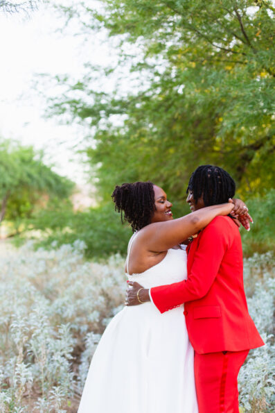 Same sex couple share an intimate moment during their intimate desert wedding by Phoenix wedding photographer Juniper and Co Photography.