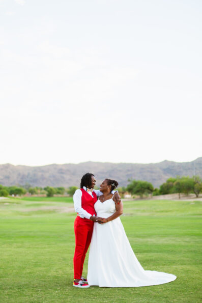 Same sex couple pose for their intimate desert wedding by Phoenix wedding photographer Juniper and Co Photography.