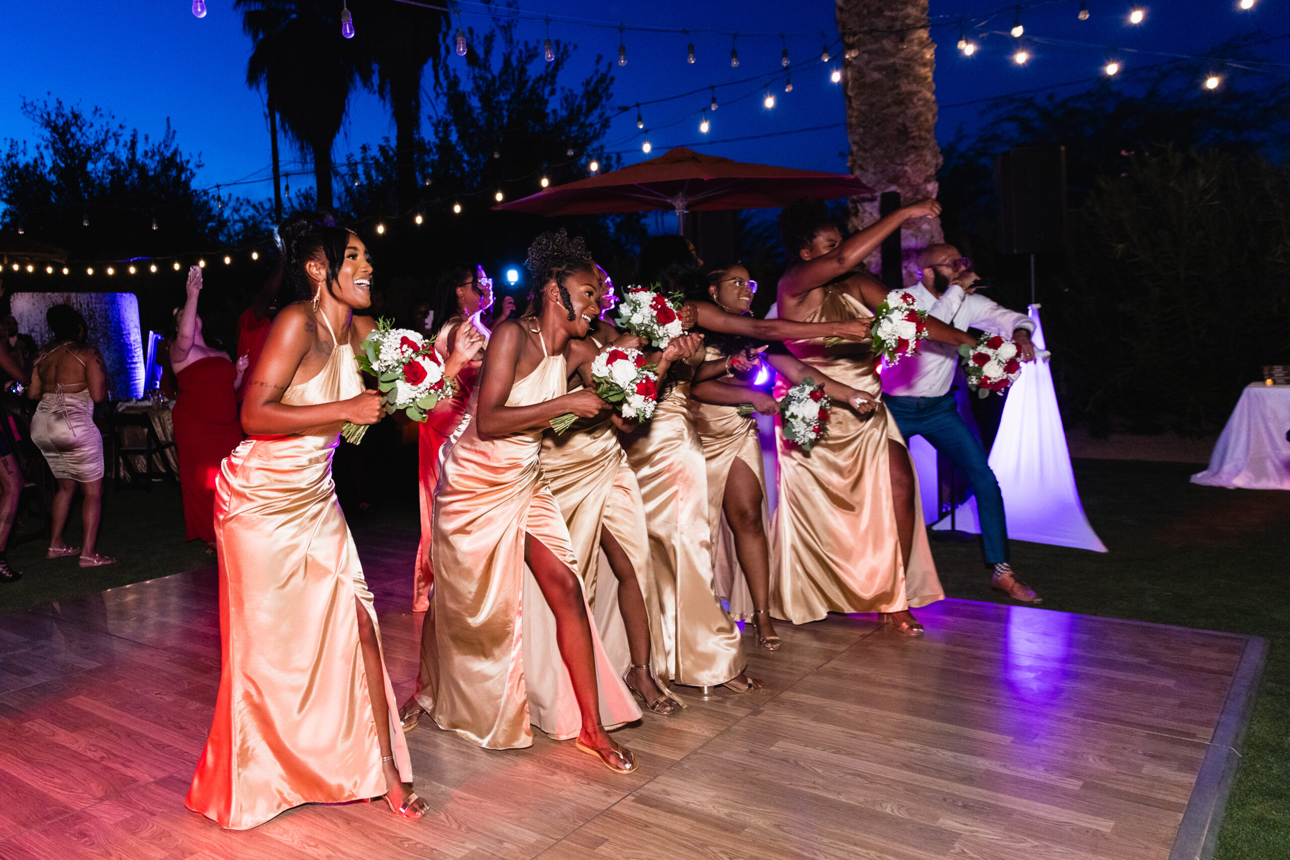 Wedding party during couple's grand entrance at intimate desert wedding reception by Phoenix wedding photographer Juniper and Co Photography.