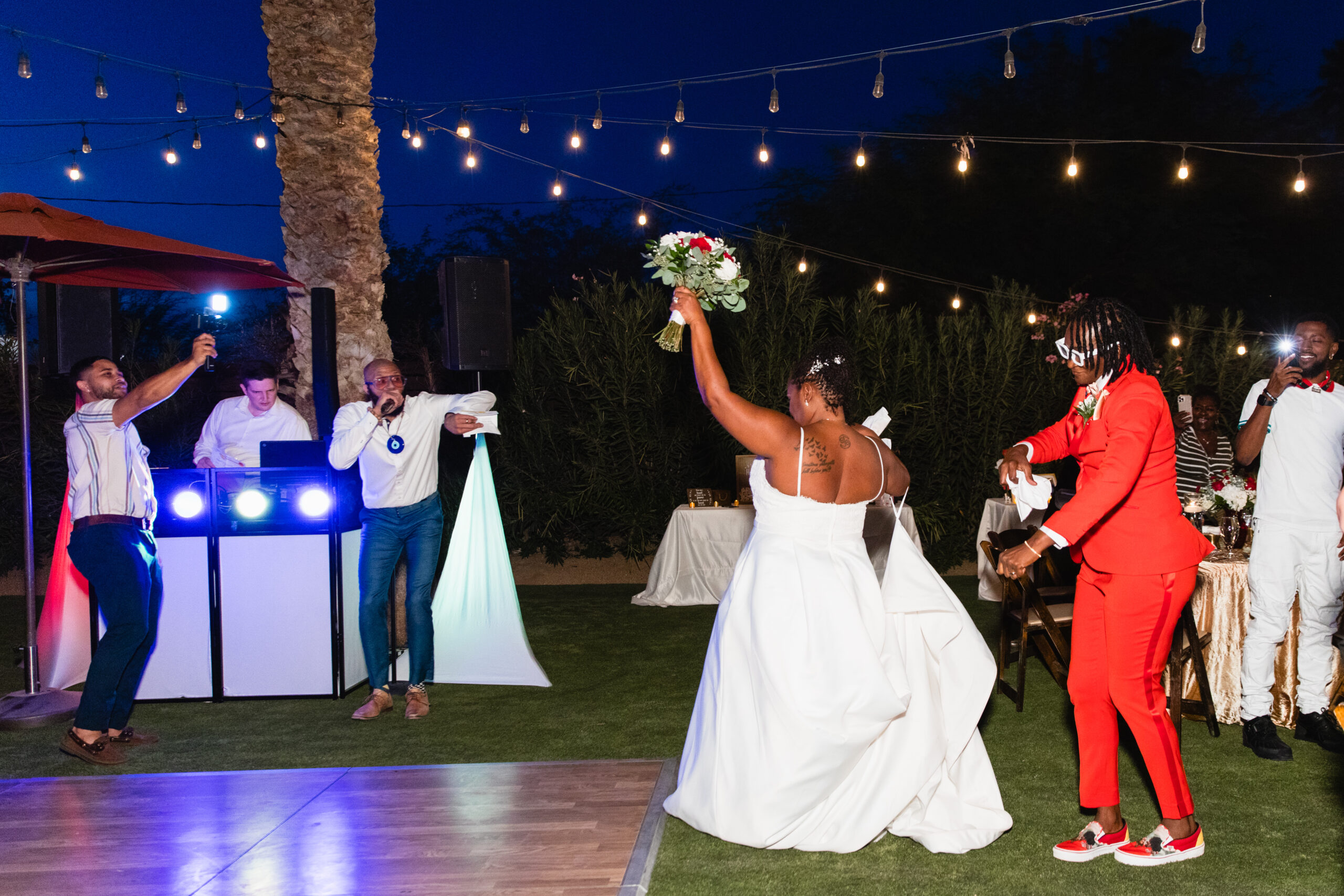 DJ and MC during couple's grand entrance at intimate desert wedding reception by Phoenix wedding photographer Juniper and Co Photography.