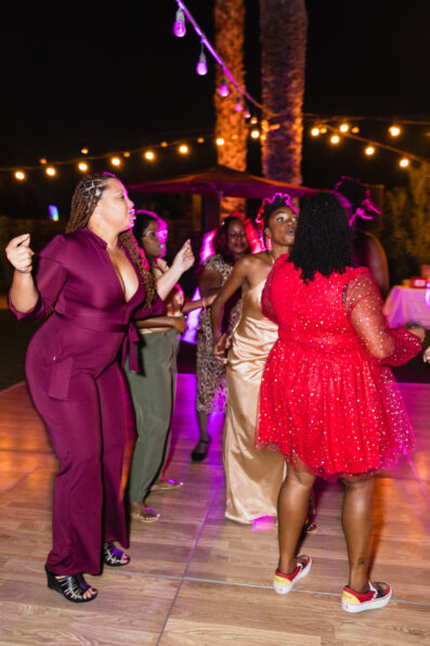 Bride dancing with guests at intimate desert wedding reception by Phoenix wedding photographer Juniper and Co Photography
