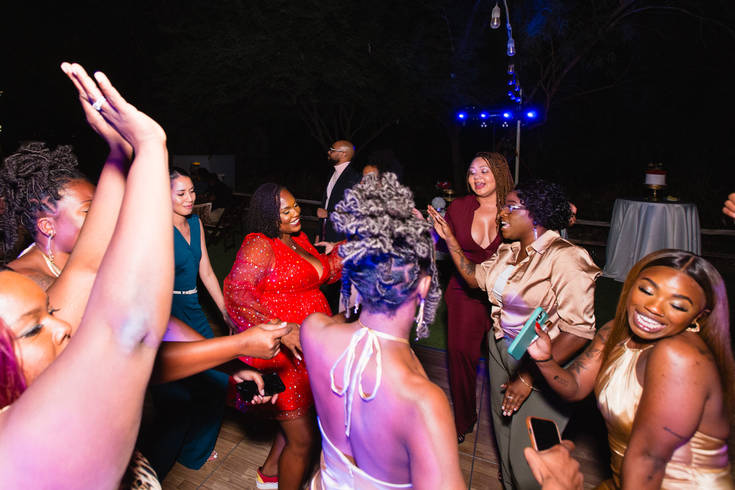 Bride dancing with guests at intimate desert wedding reception by Phoenix wedding photographer Juniper and Co Photography