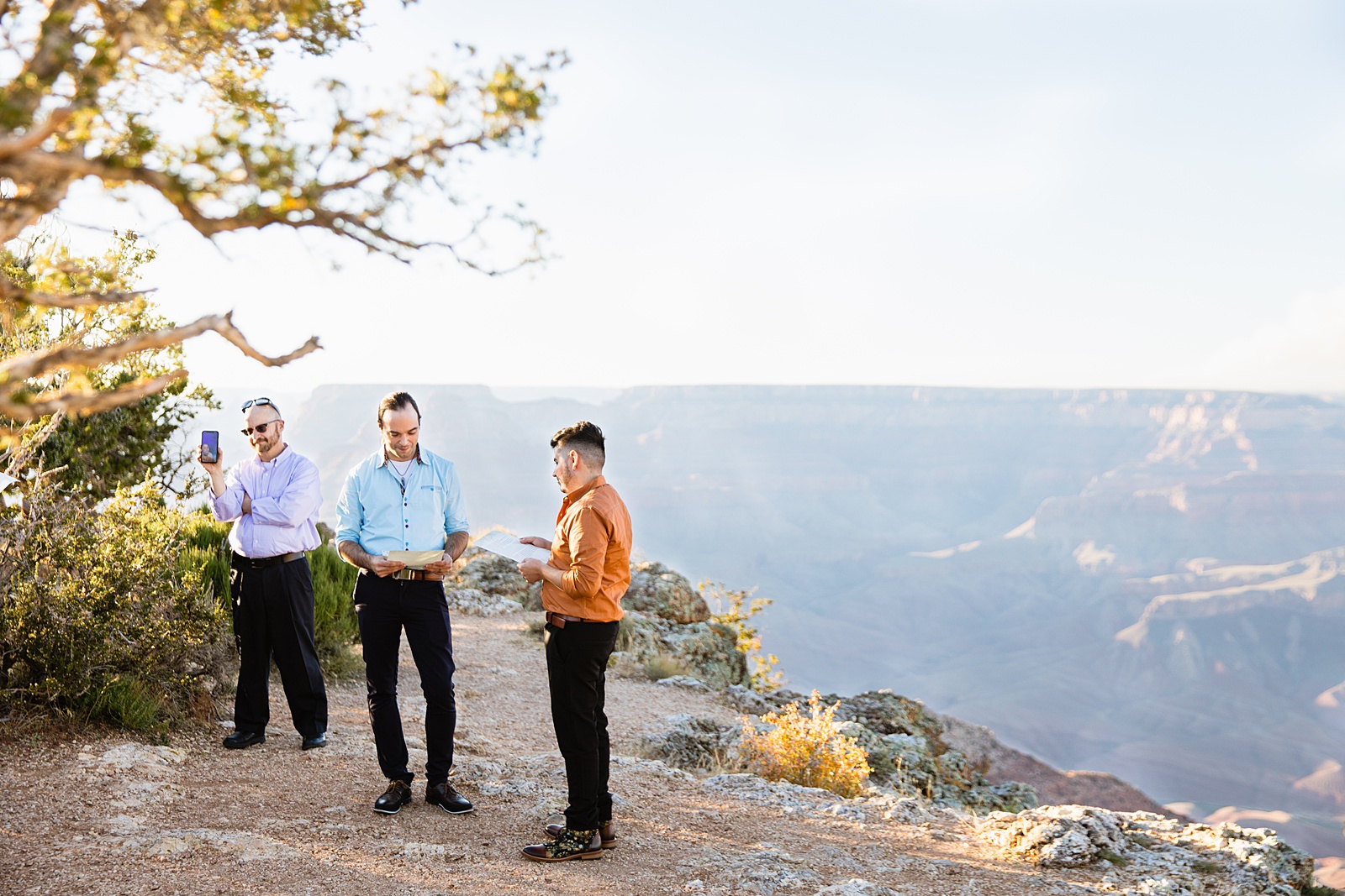 Groom looking at his groom during their vows wedding ceremony at Grand Canyon by Flagstaff elopement photographer Juniper and Co Photography.