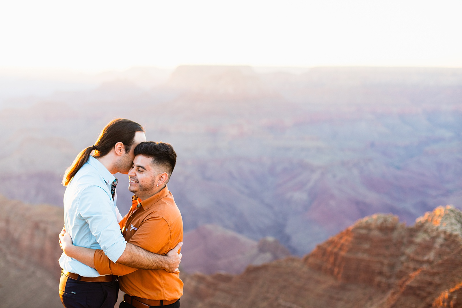 LGBTQ couple share a kiss during their Grand Canyon elopement by Flagstaff elopement photographer Juniper and Co Photography.