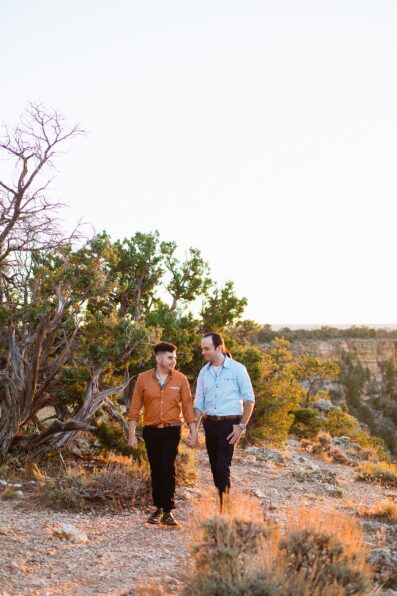 LGBTQ couple walking together during their Grand Canyon elopement by Arizona elopement photographer Juniper and Co Photography.