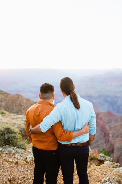 LGBTQ couple look at the Colorado River during their Grand Canyon elopement by Arizona elopement photographer Juniper and Co Photography.