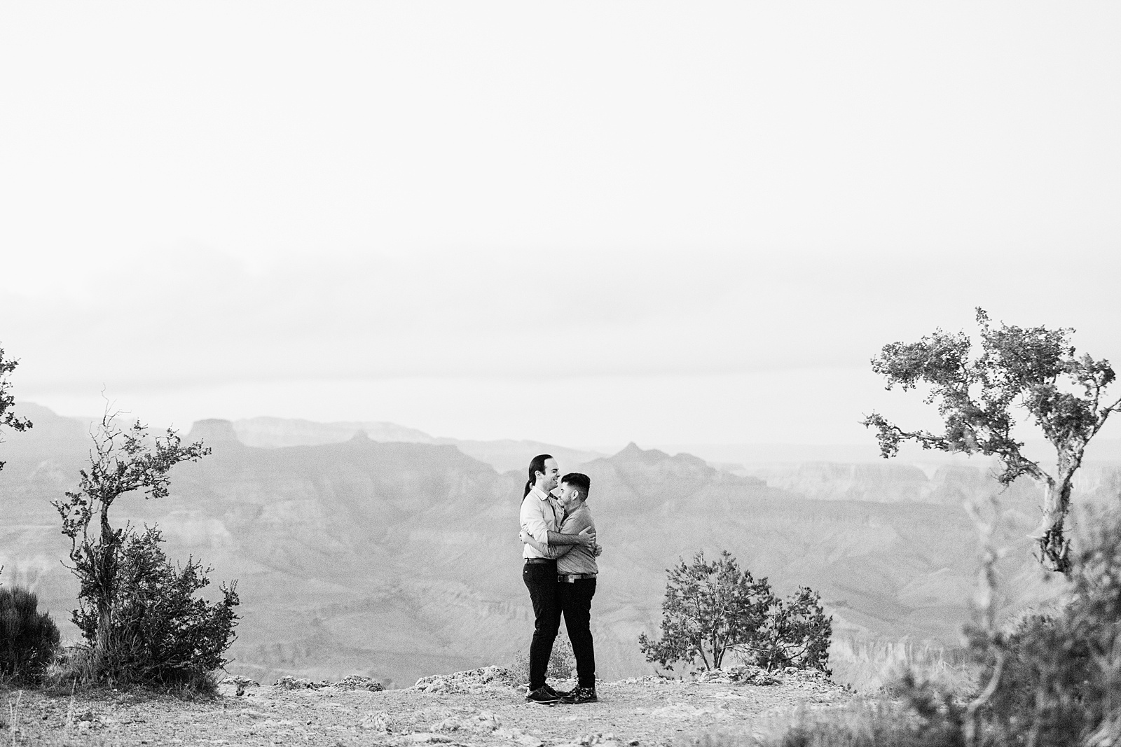 LGBTQ couple share a hug during their Grand Canyon elopement by Flagstaff elopement photographer Juniper and Co Photography.