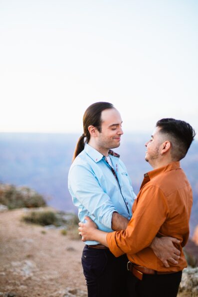 Grooms looking at each other during their Grand Canyon elopement by Arizona elopement photographer Juniper and Co Photography.