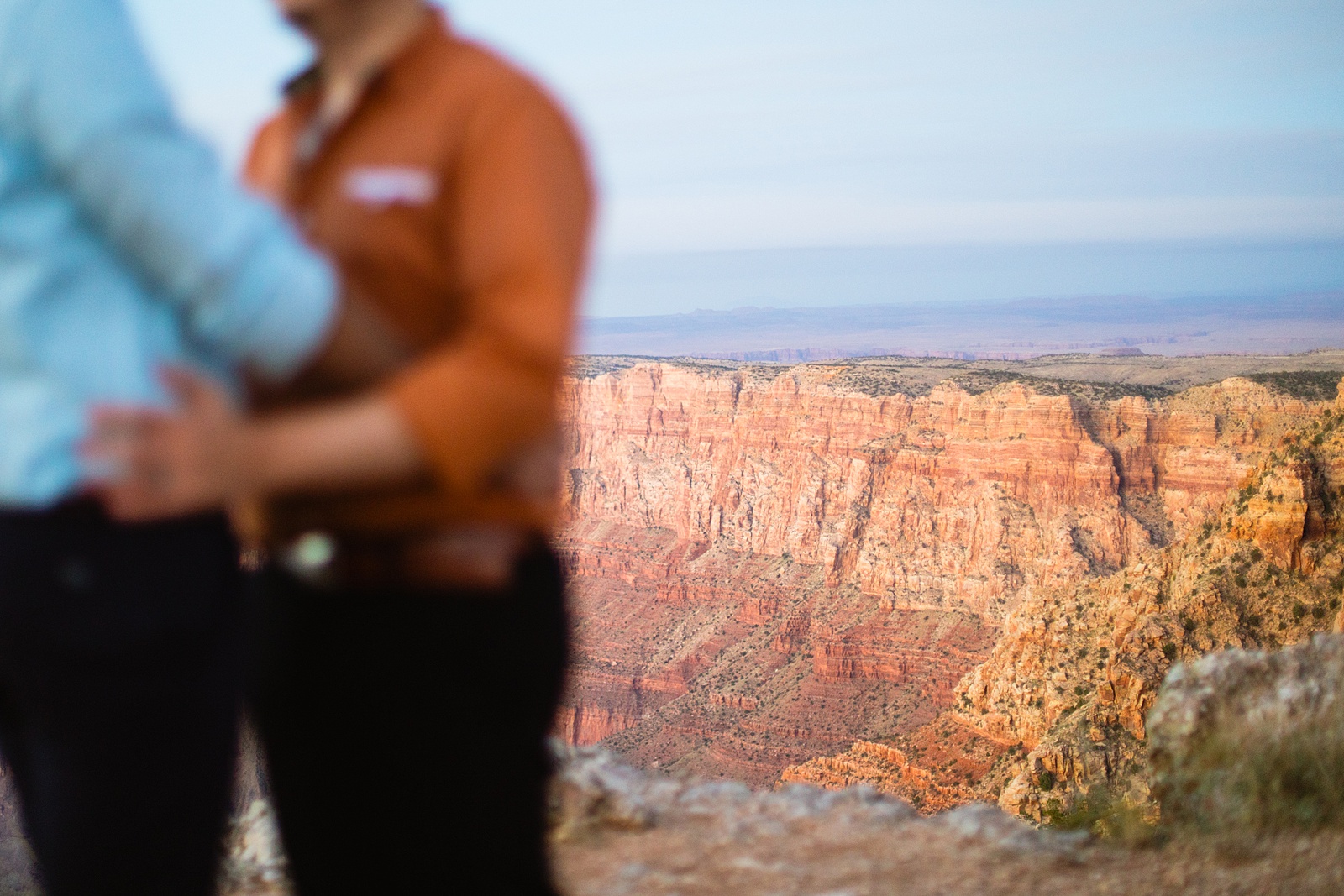 View of the canyon while same sex couple share an intimate moment during their Grand Canyon elopement by Flagstaff elopement photographer Juniper and Co Photography.