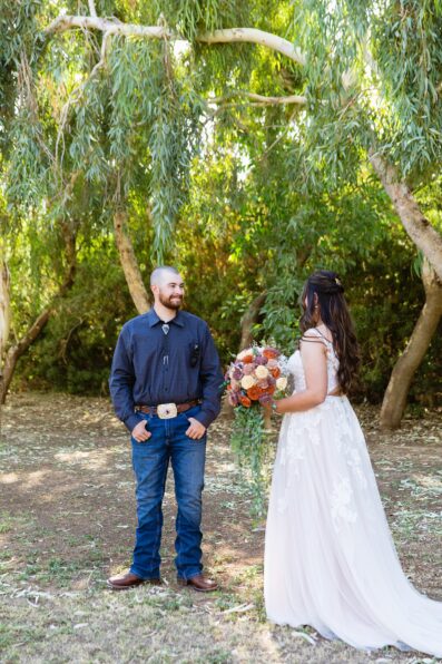 Bride & Groom share an intimate moment during their first look at intimate backyard wedding by Phoenix wedding photographer Juniper and Co Photography.