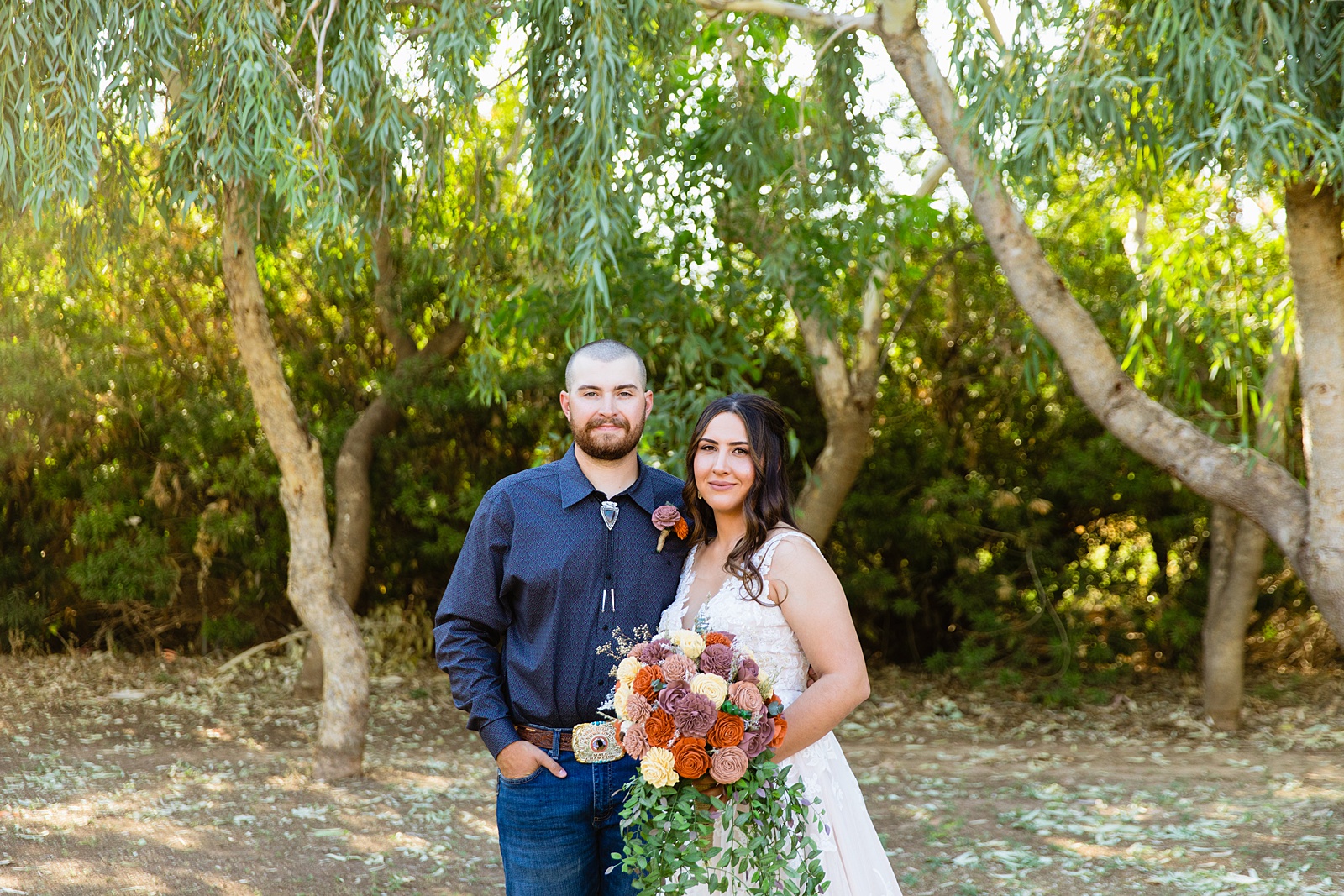 Bride & Groom pose during their intimate backyard wedding by Arizona wedding photographer Juniper and Co Photography.