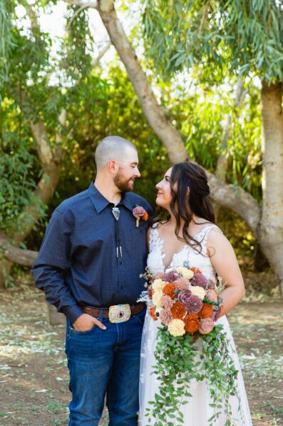 Bride & Groom pose during their intimate backyard wedding by Arizona wedding photographer Juniper and Co Photography.