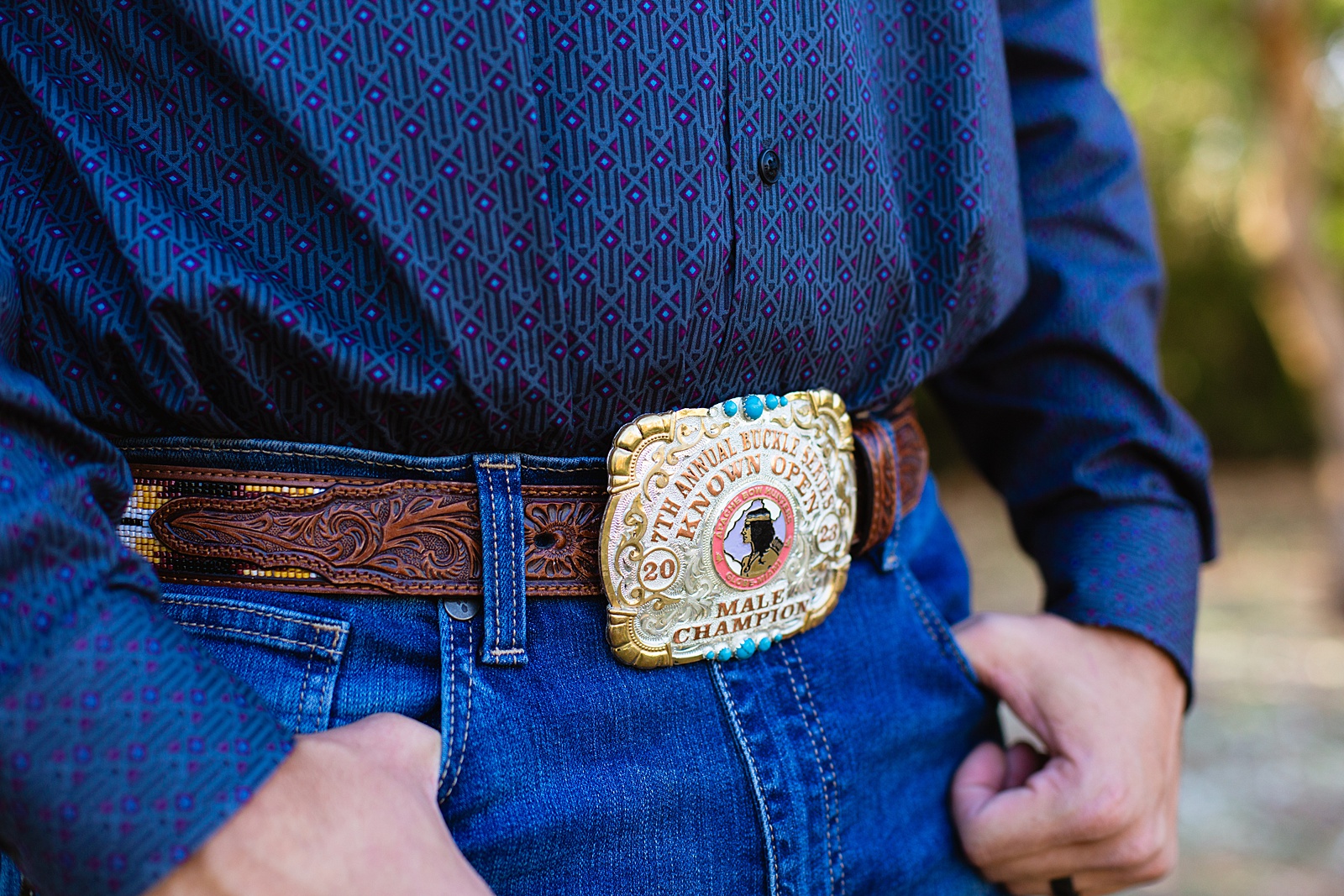 Groom's intricate cowboy buckle by Juniper and Co Photography.