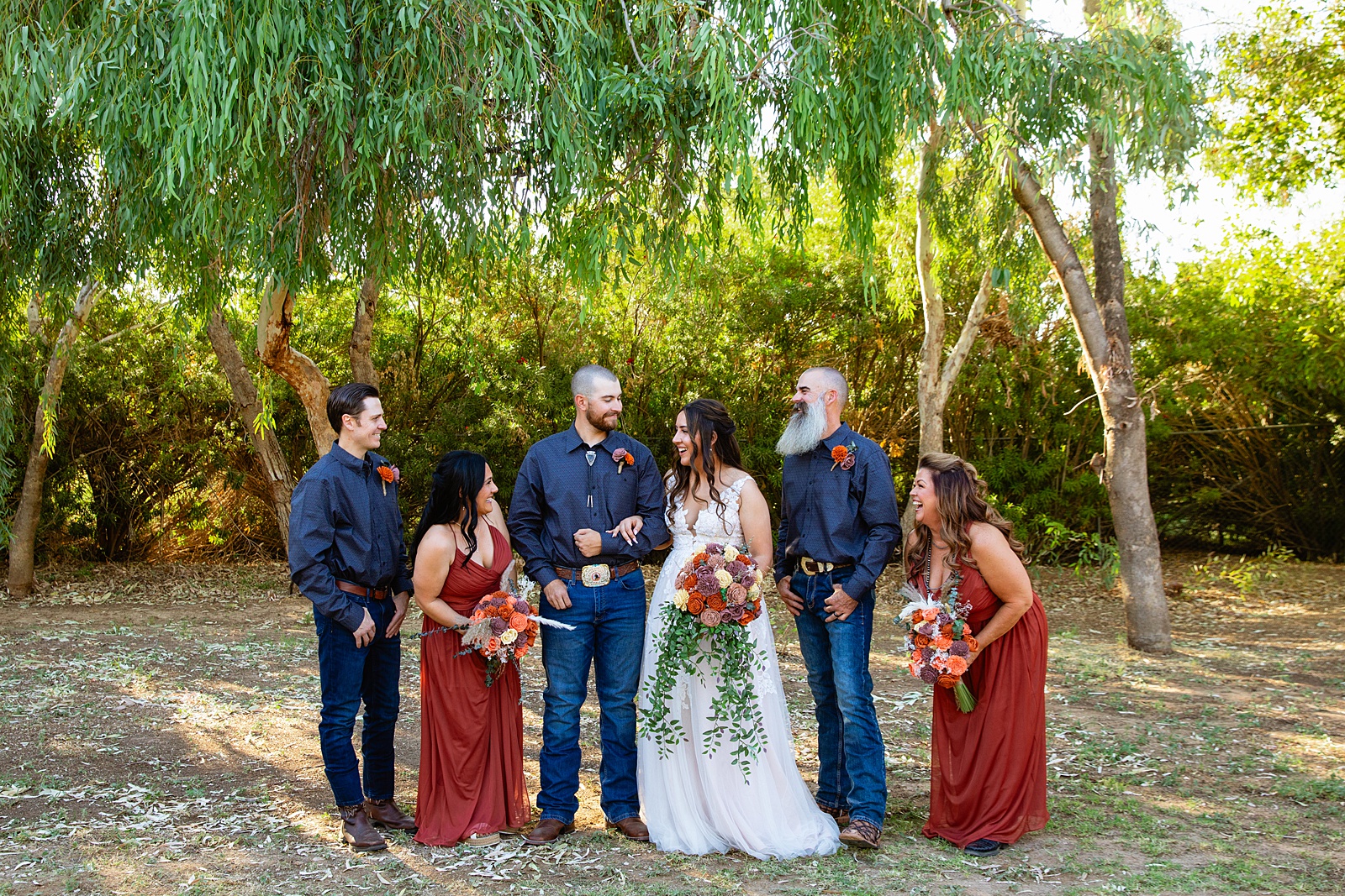 Bridal party laughing together at intimate backyard wedding by Phoenix wedding photographer Juniper and Co Photography.