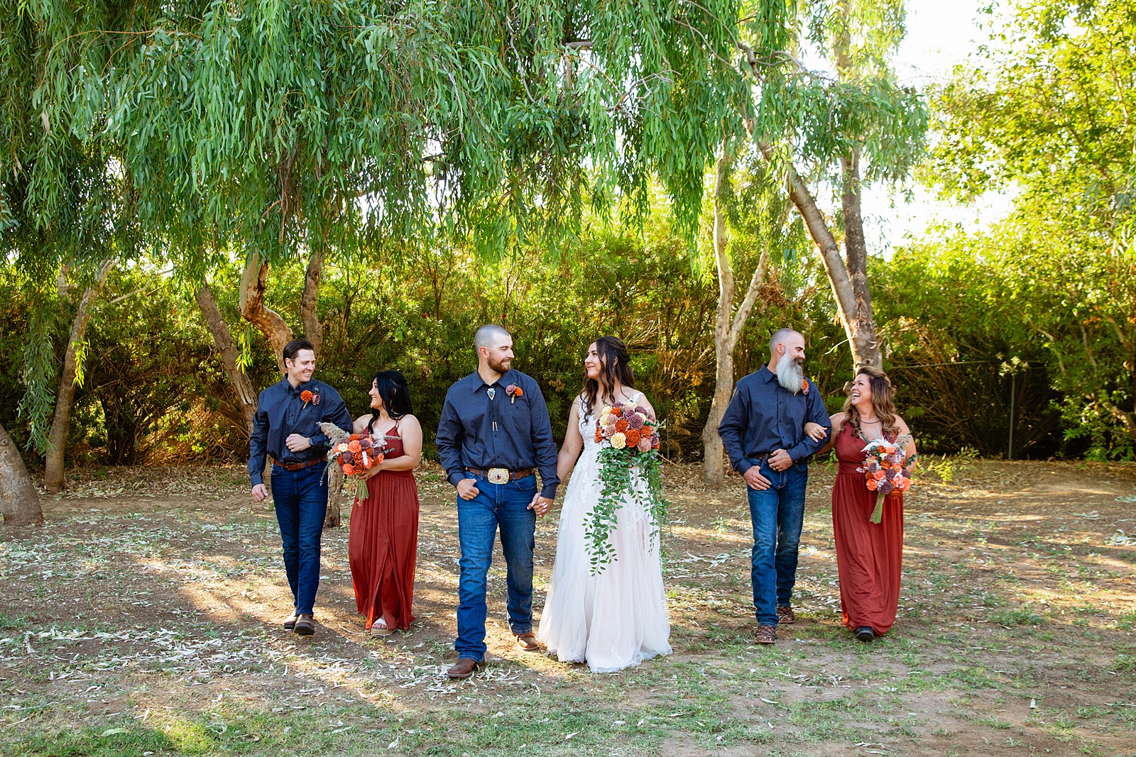 Bridal party having fun together at intimate backyard weding by Arizona wedding photographer Juniper and Co Photography.