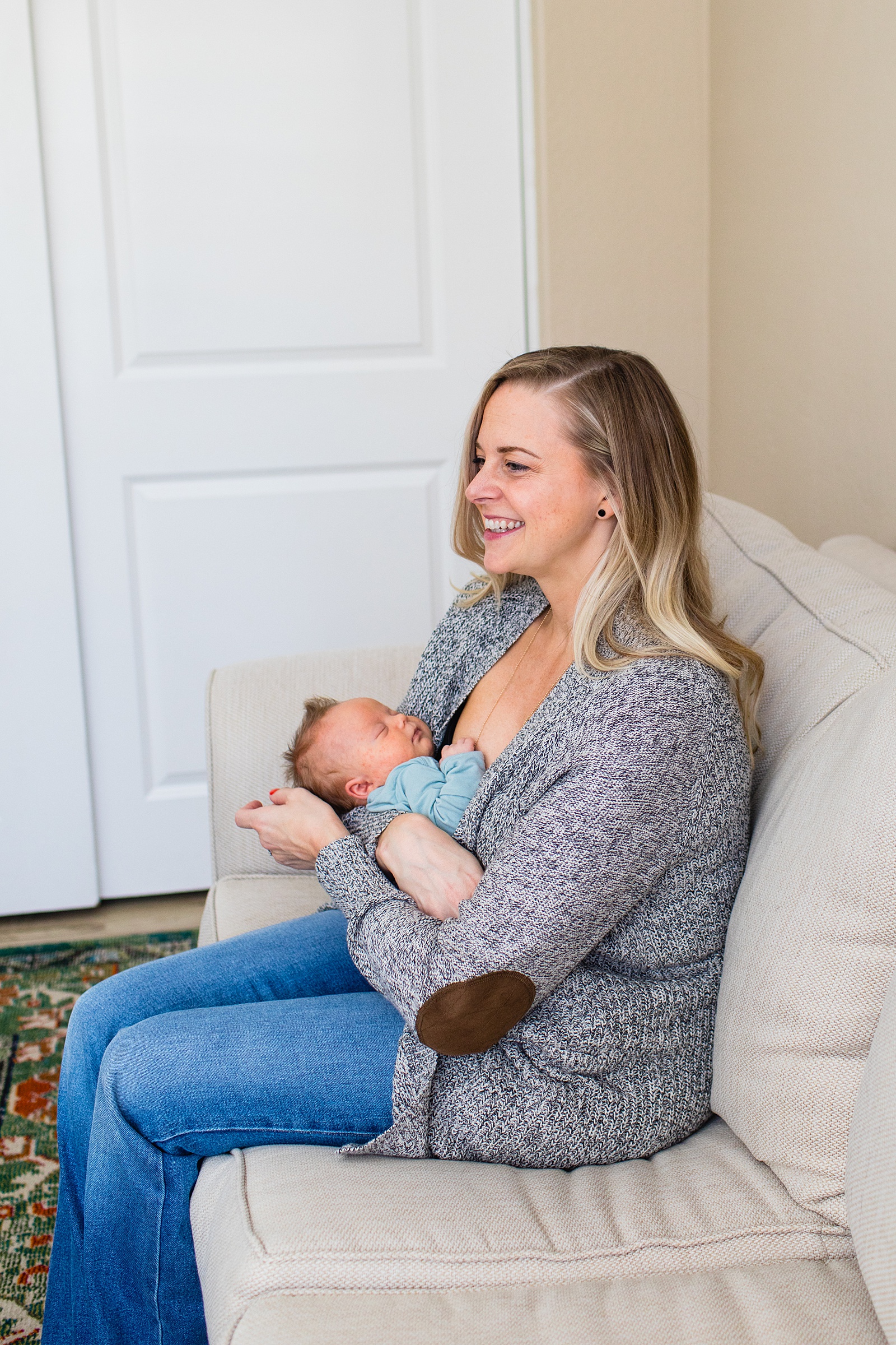 Parent poses with their baby during Phoenix In-Home Newborn session by Arizona wedding photographer Juniper and Co Photography.