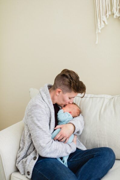 Newborn in their mother's arms during their in-home newborn Phoenix family session by Arizona family photographer Juniper and Co Photography.