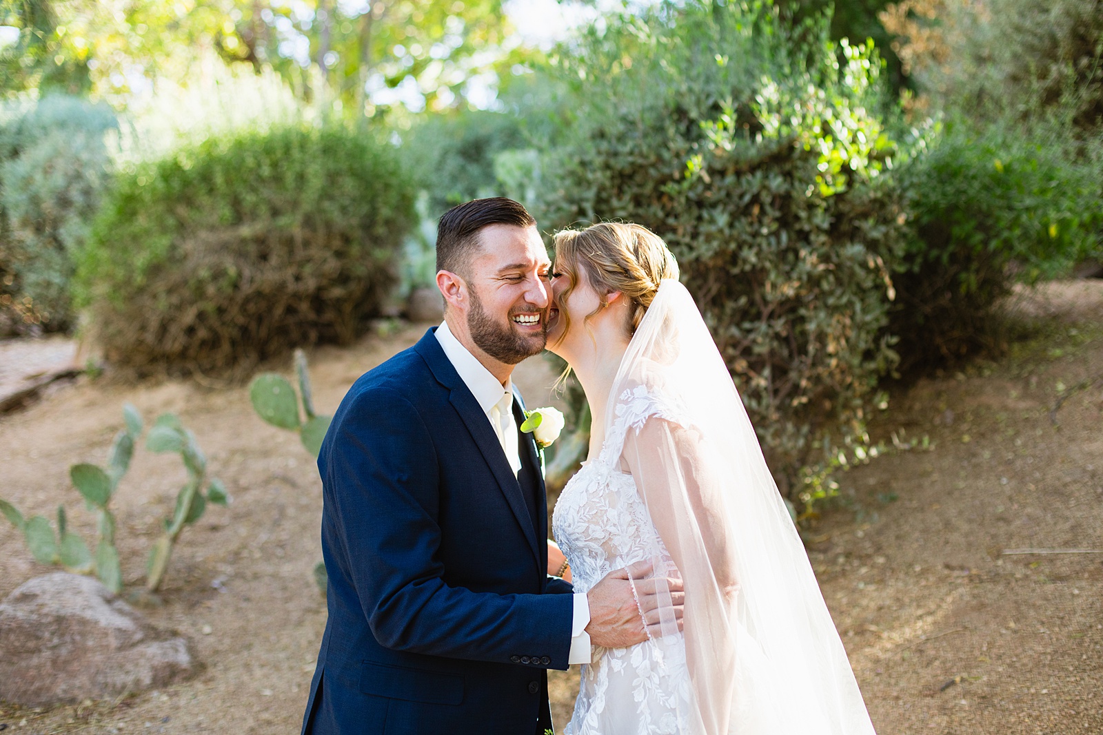 Bride & Groom share a kiss during their Sanctuary wedding by Arizona wedding photographer Juniper and Co Photography.