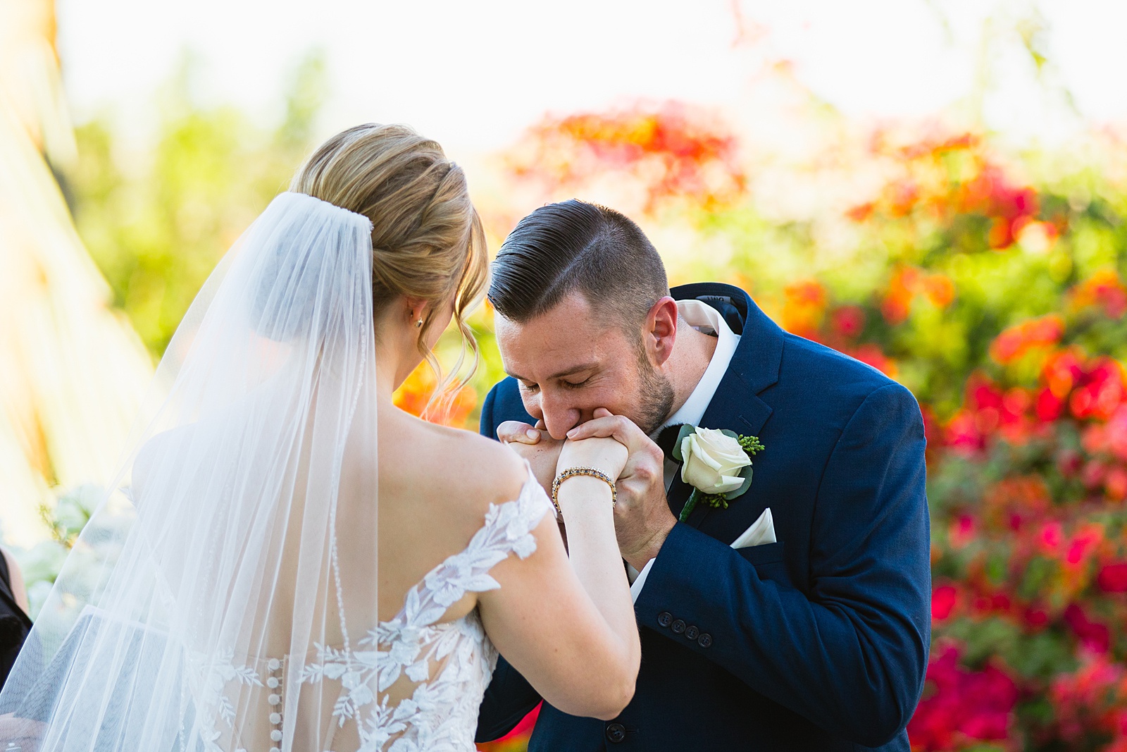 Groom kissing his bride during their wedding ceremony at Sanctuary by Phoenix wedding photographer Juniper and Co Photography.
