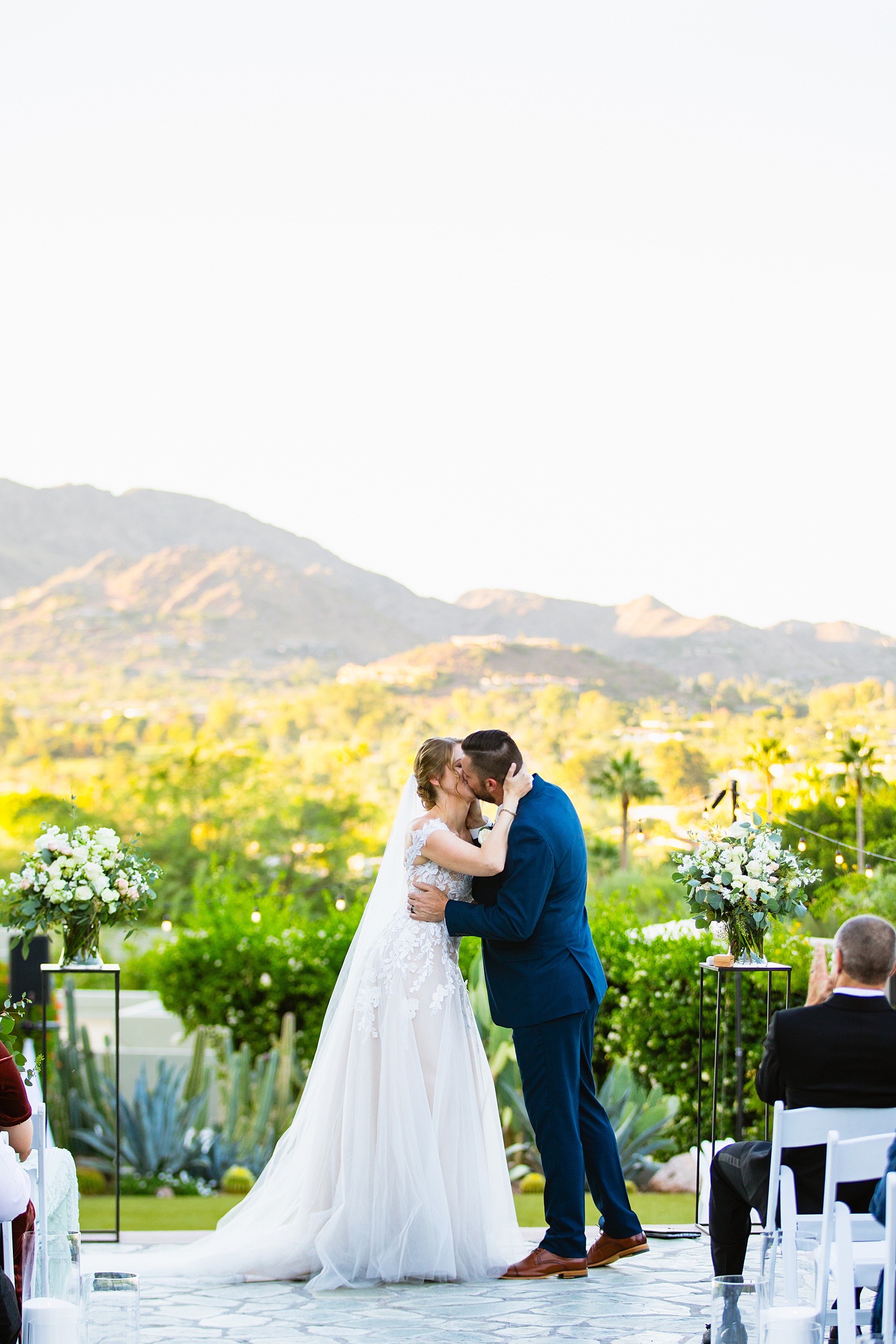 Bride & Groom share their first kiss during their wedding ceremony at Sanctuary by Arizona wedding photographer Juniper and Co Photography.
