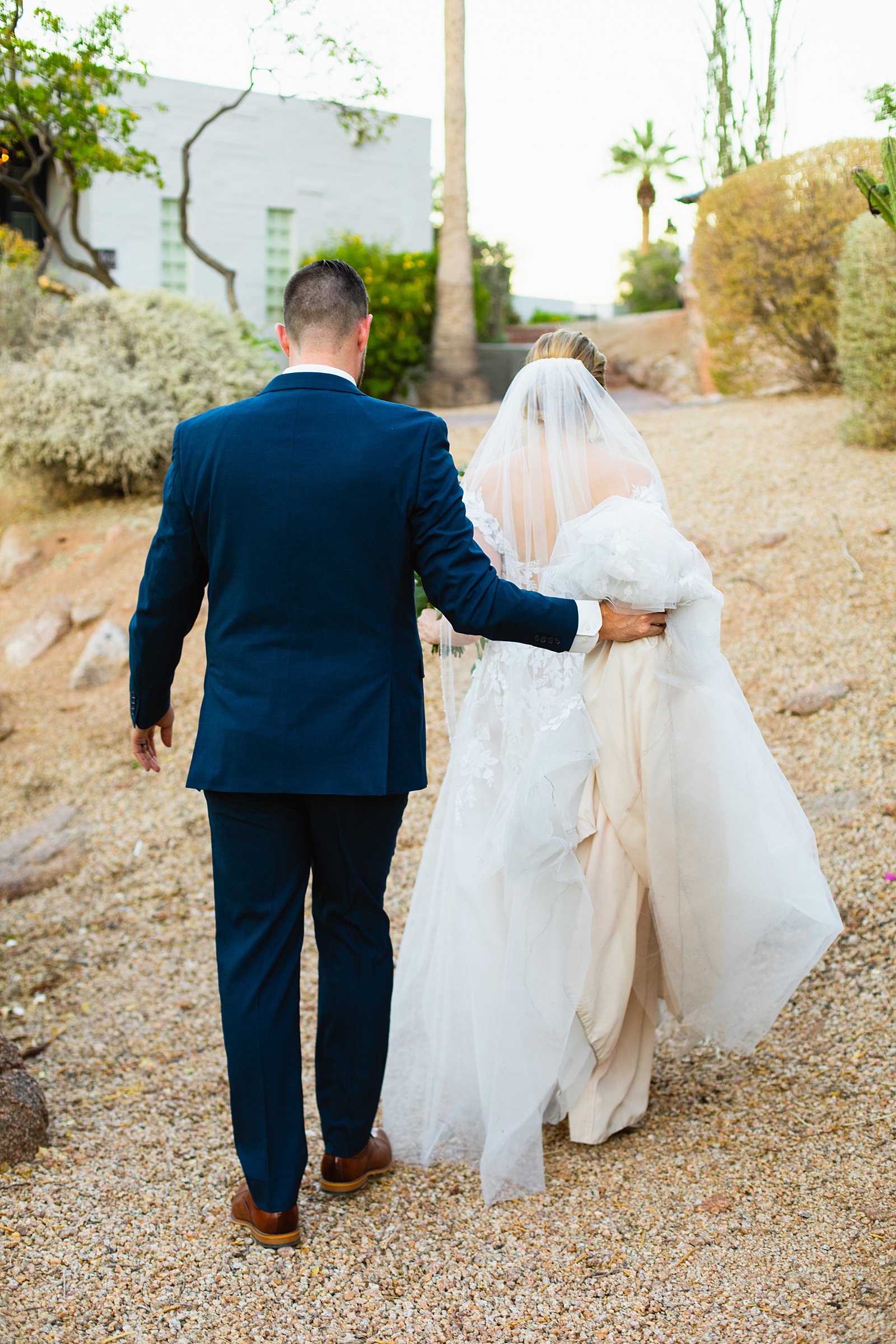 Bride & Groom walking together during their Sanctuary at Camelback wedding by Phoenix wedding photographer Juniper and Co Photography.