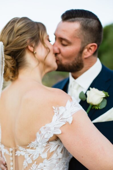 Bride & Groom share a kiss during their Sanctuary at Camelback wedding by Phoenix wedding photographer Juniper and Co Photography.