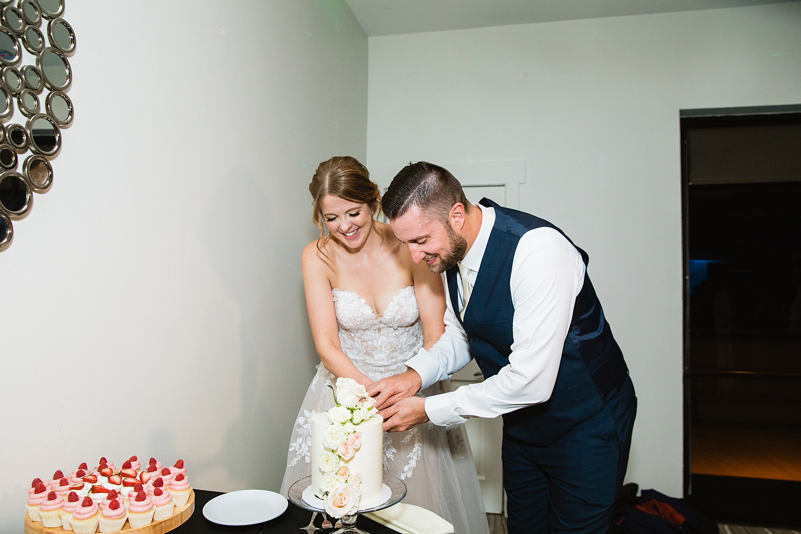 Bride & Groom cutting their wedding cake at their Sanctuary at Camelback wedding reception by Arizona wedding photographer Juniper and Co Photography.