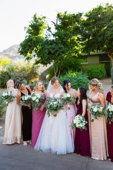 Bride and bridesmaids laughing together at Sanctuary at Camelback wedding by Phoenix wedding photographer Juniper and Co Photography.