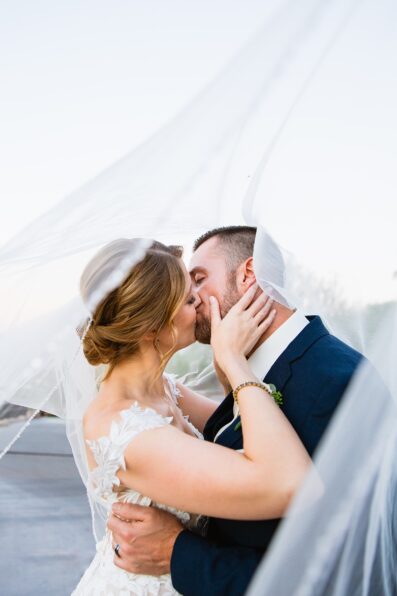 Bride & Groom share a kiss during their Sanctuary at Camelback wedding by Phoenix wedding photographer Juniper and Co Photography.