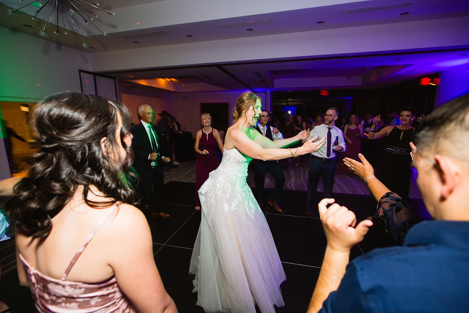 Bride dancing with guests at Sanctuary at Camelback wedding reception by Phoenix wedding photographer Juniper and Co Photography.