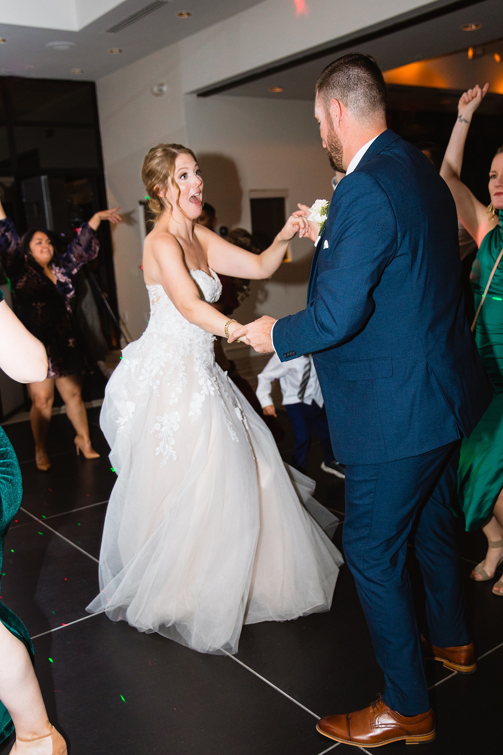 Bride & Groom dancing with guests at their Sanctuary at Camelback wedding reception by Arizona wedding photographer Juniper and Co Photography.