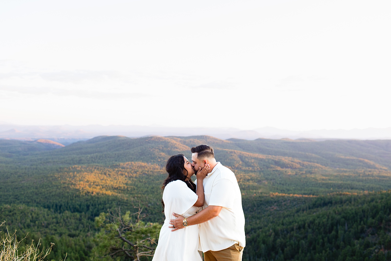 A romantic kiss between a couple during their Payson engagement session at Mogollon Rim, photographed by Arizona wedding photographer Juniper and Co Photography.